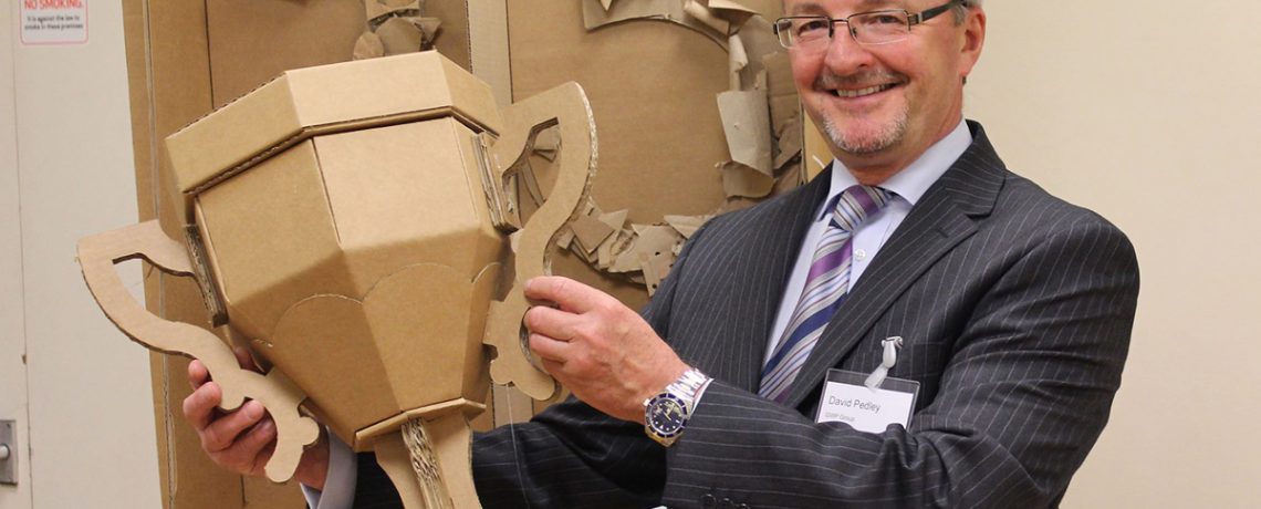 David Pedley with a cardboard trophy, created to celebrate GWP’s 25 years in business