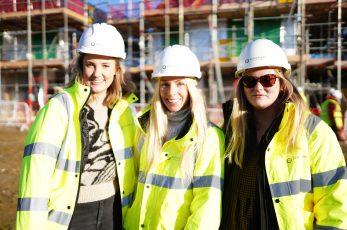 Marketing manager Jasmine Endersby, centre, with assistant Maddie Jervis and group brand manager Chloe Bennetts at the Orchard Field sustainable neighbourhood of 88 low-energy homes