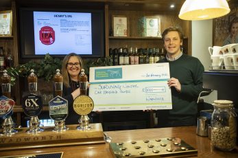 Wiltshire Community Foundation joint chief executive Vicky Hickey receiving a cheque from Wadworth chairman Toby Bartholomew