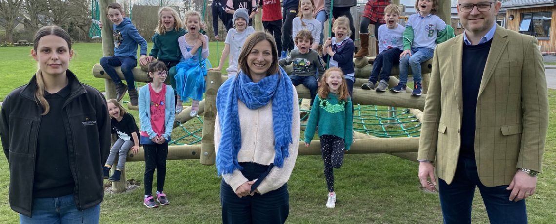 Holt Primary School headteacher Jo Hodge, centre, Stonewood Partnerships operations director Gavin Calthrop and assistant site manager Lucy Field with pupils on the new play equipment paid for with a £5,000 donation from the developer
