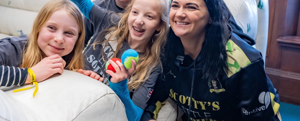 Nikki with members of Scotty's Little Soldiers backed by Goughs