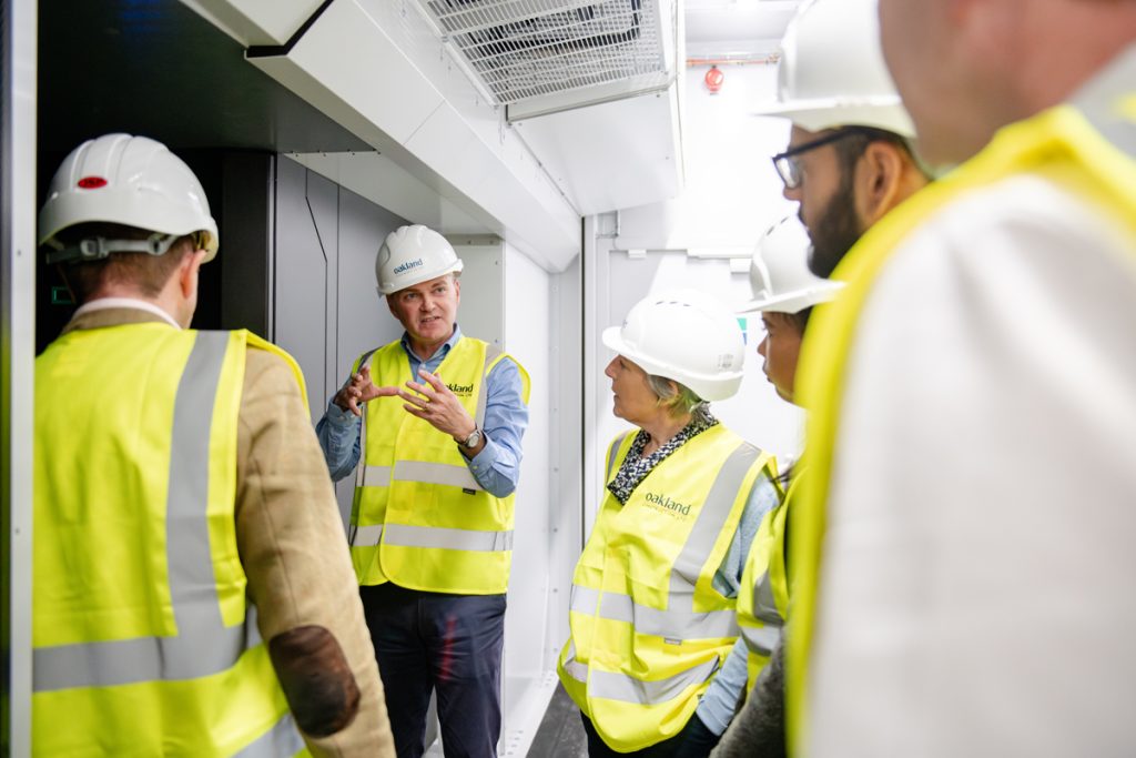 Professor Simon McIntosh-Smith with delegation inside Isambard-3