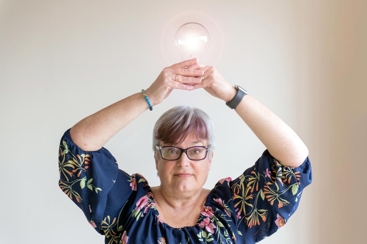Fiona Scott holding lightbulb above her head
