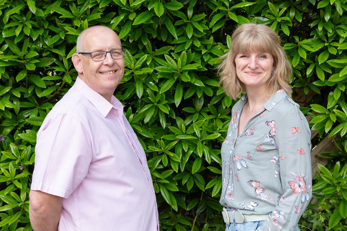 Paul and Layla from Filestream, on a sunny day in front of a hedge
