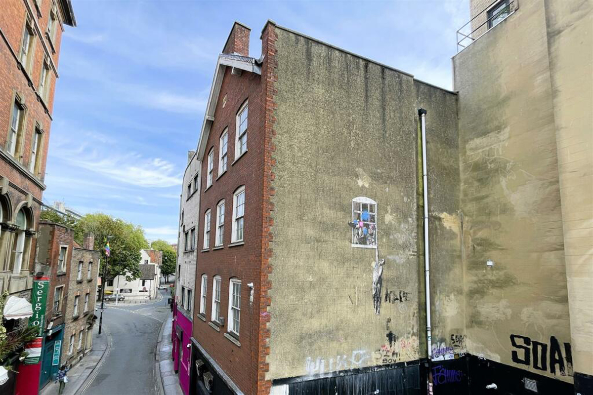 Bristol estate agent Hollis Morgan will be getting a reputation as an art dealer, as well as a seller of houses. Just days after selling a building with an early Banksy mural on the side elevation, the firm has brought to market another property – with perhaps the street artist's best-known Bristol mural as a prominent feature.