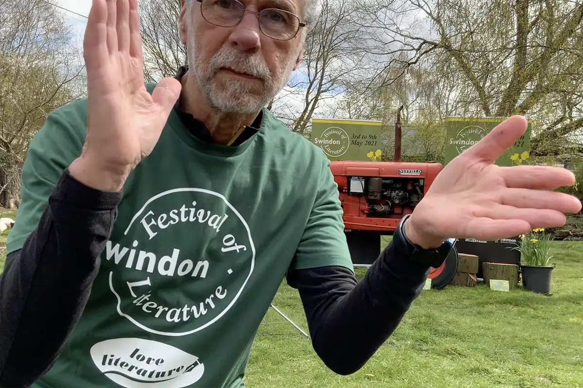 Matt Holland about to clap and launch the Swindon Festival of Literature 2025